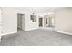 Spacious living room with gray carpet, open floor plan, and neutral walls at 6800 E Lake Mead Blvd # 1018, Las Vegas, NV 89156