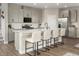 Modern kitchen with stainless steel appliances and an island with barstool seating at 7394 Daly Grove St, Las Vegas, NV 89113