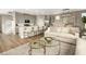 Open living space featuring a kitchen island, dining table, and sofas at 7394 Daly Grove St, Las Vegas, NV 89113