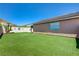 Expansive backyard with artificial turf and mature landscaping at 7488 Evening Falls Dr, Las Vegas, NV 89131