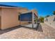Backyard features a covered patio and brick laid hardscape at 7488 Evening Falls Dr, Las Vegas, NV 89131