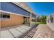 Backyard patio with covered area, low maintenance landscaping, and privacy wall at 7488 Evening Falls Dr, Las Vegas, NV 89131