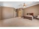 Spacious bedroom with neutral walls, vaulted ceiling, ceiling fan, and a large bed with side tables at 7488 Evening Falls Dr, Las Vegas, NV 89131
