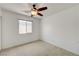 Clean bedroom with ceiling fan, window, and carpeted floors at 7488 Evening Falls Dr, Las Vegas, NV 89131