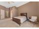 A spacious bedroom with neutral walls, carpet flooring, a ceiling fan, and a large bed at 7488 Evening Falls Dr, Las Vegas, NV 89131