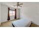 Bright bedroom with a ceiling fan and window offering natural light at 7488 Evening Falls Dr, Las Vegas, NV 89131