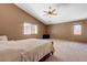 Bright, large bedroom with vaulted ceiling, two windows, neutral walls, ceiling fan, and carpet flooring at 7488 Evening Falls Dr, Las Vegas, NV 89131