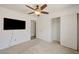 Spacious carpeted bedroom with ceiling fan, closet, and TV at 7488 Evening Falls Dr, Las Vegas, NV 89131