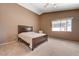 A spacious bedroom with neutral walls and carpet flooring, a bed, and a ceiling fan at 7488 Evening Falls Dr, Las Vegas, NV 89131