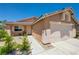 Front of house featuring walkway to front door, two car garage and desert landscaping at 7488 Evening Falls Dr, Las Vegas, NV 89131