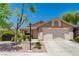 Attractive home with mature landscaping, two-car garage, and a neatly maintained front yard at 7488 Evening Falls Dr, Las Vegas, NV 89131