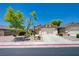 Inviting single-story home featuring a well-manicured front yard, lush landscaping, and attached two-car garage at 7488 Evening Falls Dr, Las Vegas, NV 89131