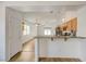 Bright kitchen featuring wood cabinets, stainless appliances, and an open view to the living area at 7488 Evening Falls Dr, Las Vegas, NV 89131