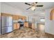 Spacious kitchen featuring stainless steel appliances, tile floors and light wood cabinetry at 7488 Evening Falls Dr, Las Vegas, NV 89131