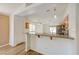 Bright kitchen featuring wood cabinets, stainless appliances, and an open view to the living area at 7488 Evening Falls Dr, Las Vegas, NV 89131