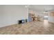 Open-concept living space with tile flooring and stainless steel appliances in the adjacent kitchen at 7488 Evening Falls Dr, Las Vegas, NV 89131