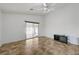 Living room featuring neutral paint, tile floors, and a sliding glass door to the backyard at 7488 Evening Falls Dr, Las Vegas, NV 89131