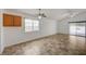 Bright living room featuring neutral paint, tile floors, and a sliding glass door to the backyard at 7488 Evening Falls Dr, Las Vegas, NV 89131