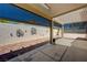 Covered patio with brick flooring, decorative backyard wall art and sun shades at 7488 Evening Falls Dr, Las Vegas, NV 89131
