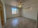 Bright bedroom featuring ample natural light, ceiling fan, and tile flooring at 8042 Palace Monaco Ave, Las Vegas, NV 89117