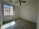 This bedroom features a ceiling fan, natural light, and tile flooring at 8042 Palace Monaco Ave, Las Vegas, NV 89117