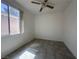 Cozy bedroom featuring a ceiling fan, natural light, and tile flooring at 8042 Palace Monaco Ave, Las Vegas, NV 89117