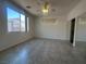 Bright bedroom featuring ample natural light, closet with mirrored doors, and tile flooring at 8042 Palace Monaco Ave, Las Vegas, NV 89117