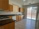 Bright kitchen with wood cabinets, tile floors, and a sliding door to the exterior at 8042 Palace Monaco Ave, Las Vegas, NV 89117