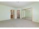 Spacious bedroom featuring an ensuite bathroom and mirrored closet doors at 8244 Horseshoe Bend Ln, Las Vegas, NV 89113