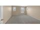 Empty bedroom featuring neutral walls, carpet flooring, and bright windows with shutters at 9100 Hombard Ave, Las Vegas, NV 89148