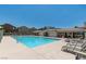 Community pool with lounge chairs and shade at 9100 Hombard Ave, Las Vegas, NV 89148