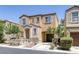 Two-story home showcasing an inviting entry and attached garage, complemented by manicured landscaping, exuding curb appeal at 9100 Hombard Ave, Las Vegas, NV 89148