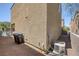 Exterior of home with gravel yard, air conditioning unit, and trash bins at 9100 Hombard Ave, Las Vegas, NV 89148