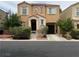 Charming two-story home featuring a quaint front porch and attached garage at 9100 Hombard Ave, Las Vegas, NV 89148