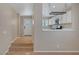 Inviting foyer leading to a stylish kitchen, featuring white cabinets and natural light, perfect for cooking and entertaining at 9100 Hombard Ave, Las Vegas, NV 89148