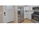 View of kitchen appliances and white cabinets. Includes stainless steel fridge and gas burning stove at 9100 Hombard Ave, Las Vegas, NV 89148