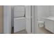 Efficient laundry area with stacked washer and dryer near bathroom at 9100 Hombard Ave, Las Vegas, NV 89148
