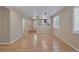 Open-concept living space with laminate wood flooring and an arched doorway to a kitchen at 9100 Hombard Ave, Las Vegas, NV 89148