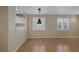 Bright living space with laminate wood flooring, neutral walls, and stylish pendant lighting at 9100 Hombard Ave, Las Vegas, NV 89148