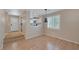 Open-concept living area with laminate wood flooring and natural light from a large window at 9100 Hombard Ave, Las Vegas, NV 89148