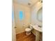 Well-lit powder room with pedestal sink and modern fixtures at 9100 Hombard Ave, Las Vegas, NV 89148