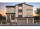 Modern two-story home with neutral stucco, brown trim, and a two-car garage showcasing an eye-catching facade at 10236 Rosemont Hills St, Las Vegas, NV 89141
