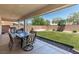 Backyard featuring a lawn and covered patio with dining set at 1034 Fish Pond Ave, Henderson, NV 89014