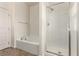 Bright bathroom featuring a soaking tub and glass-enclosed shower at 1034 Fish Pond Ave, Henderson, NV 89014