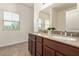 Bathroom vanity with dual sinks, cabinets, and a large mirror at 1034 Fish Pond Ave, Henderson, NV 89014