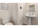 Half bathroom with pedestal sink, tiled floors, and 'Wash Your Hands' decor at 1034 Fish Pond Ave, Henderson, NV 89014