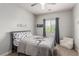 Charming room with themed bedding, chair, and ample sunlight at 1034 Fish Pond Ave, Henderson, NV 89014