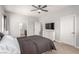 Bedroom with ceiling fan, carpet flooring, a large dresser, and a view into the en suite bathroom at 1034 Fish Pond Ave, Henderson, NV 89014