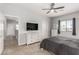 Bedroom with carpet, a TV, large dresser, ceiling fan, and natural light at 1034 Fish Pond Ave, Henderson, NV 89014
