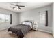 Cozy bedroom with a ceiling fan, carpet, and natural light from two windows at 1034 Fish Pond Ave, Henderson, NV 89014